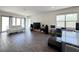 Modern living room with a white sofa, large windows, and wood-look tile flooring at 10879 Artesano Ave, Las Vegas, NV 89135