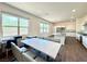 Open-concept area featuring wood-look tile, natural light, and a view of the modern kitchen at 10879 Artesano Ave, Las Vegas, NV 89135