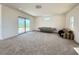 Spacious living room with a sliding glass door to a balcony at 10879 Artesano Ave, Las Vegas, NV 89135