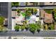 An aerial view of a home with a pool, greenery, solar panels, and a parking lot nearby at 1115 Melville Dr, Las Vegas, NV 89102