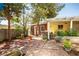 Spacious backyard with brick pavers, mature trees, and seating areas at 1115 Melville Dr, Las Vegas, NV 89102