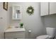 Clean bathroom featuring a white vanity, toilet, and neutral decor at 1115 Melville Dr, Las Vegas, NV 89102