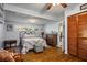 Comfortable bedroom with wood floors, window views, and closet with bi-fold doors at 1115 Melville Dr, Las Vegas, NV 89102