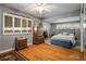 Spacious bedroom with hardwood floors, large windows, and ample closet space at 1115 Melville Dr, Las Vegas, NV 89102
