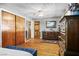 Bright bedroom with hardwood floors, large wardrobe, and neutral wall color at 1115 Melville Dr, Las Vegas, NV 89102