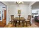 Charming dining area with a wooden table set for two, adjacent to the living area at 1115 Melville Dr, Las Vegas, NV 89102