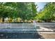 Inviting home exterior behind a neat white picket fence and mature trees, showcasing curb appeal at 1115 Melville Dr, Las Vegas, NV 89102