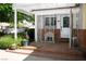 Welcoming front porch with a wrought-iron gate, mature plants, and stylish decor at 1115 Melville Dr, Las Vegas, NV 89102