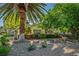Charming single-story home with desert landscaping, mature trees, and a welcoming curb appeal at 1115 Melville Dr, Las Vegas, NV 89102
