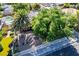 Charming front yard featuring mature landscaping, a large palm tree, and a white picket fence at 1115 Melville Dr, Las Vegas, NV 89102