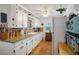 Charming kitchen with white cabinets, brick backsplash, granite counters and tile floors at 1115 Melville Dr, Las Vegas, NV 89102
