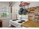 Cozy kitchen featuring a white stove, speckled granite countertops, and unique brick backsplash at 1115 Melville Dr, Las Vegas, NV 89102