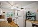 Bright and airy kitchen with white appliances, classic tile flooring, and ample storage at 1115 Melville Dr, Las Vegas, NV 89102