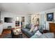 Bright living room with tile floors, access to the kitchen and backyard, and stylish decor at 1115 Melville Dr, Las Vegas, NV 89102