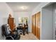 Home office with neutral carpet, desk, office chair, and window with plantation shutters at 1115 Melville Dr, Las Vegas, NV 89102
