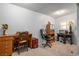 Home office with neutral carpet, desk, office chair, filing cabinet, and window at 1115 Melville Dr, Las Vegas, NV 89102