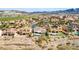 Scenic aerial view of a desert community showcasing homes with red tile roofs, landscaping, and mountain views on the horizon at 1223 Casa Palermo Circle Cir, Henderson, NV 89011