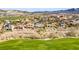 Expansive aerial view of homes in a golf course community with desert landscaping and picturesque mountain views at 1223 Casa Palermo Circle Cir, Henderson, NV 89011
