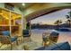 Relaxing backyard featuring outdoor seating, a covered patio, and a sparkling pool with a water feature at 1223 Casa Palermo Circle Cir, Henderson, NV 89011