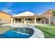 Beautiful backyard featuring a pool, covered patio, and low-maintenance artificial grass at 1223 Casa Palermo Circle Cir, Henderson, NV 89011