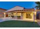 Evening shot of the backyard featuring a covered patio, pool, spa, and lush landscaping at 1223 Casa Palermo Circle Cir, Henderson, NV 89011