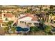 Gorgeous backyard with a pristine pool, patio cover, and lush landscaping in a desert community at 1223 Casa Palermo Circle Cir, Henderson, NV 89011