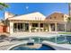 A beautifully landscaped backyard features a pool and spa area with covered patio and modern architectural details at 1223 Casa Palermo Circle Cir, Henderson, NV 89011