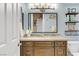 Stylish bathroom with wood vanity, marble countertop, decorative mirror, and open shelving at 1223 Casa Palermo Circle Cir, Henderson, NV 89011