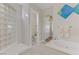Bright bathroom featuring a soaking tub, shower with glass blocks, and an arched hallway entrance at 1223 Casa Palermo Circle Cir, Henderson, NV 89011