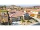 Inviting front exterior view showcasing a desert home with stone accents, a red tile roof, and a well-manicured front yard at 1223 Casa Palermo Circle Cir, Henderson, NV 89011