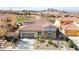 Charming front exterior of a single-Gathering home with a red tile roof, stone accents, and desert landscaping at 1223 Casa Palermo Circle Cir, Henderson, NV 89011