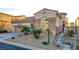 Charming stone-accented home featuring a desert landscaped front yard and attached two-car garage at 1223 Casa Palermo Circle Cir, Henderson, NV 89011