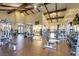 Spacious gym featuring an open layout, wood floors, high ceilings with exposed wood beams, and a variety of exercise equipment at 1223 Casa Palermo Circle Cir, Henderson, NV 89011