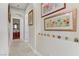Inviting hallway with tile flooring, neutral walls, arched entries and decorative artwork display at 1223 Casa Palermo Circle Cir, Henderson, NV 89011