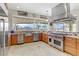 Gourmet kitchen with stainless steel appliances, granite countertops, and scenic backyard views at 1223 Casa Palermo Circle Cir, Henderson, NV 89011