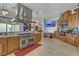 Spacious kitchen boasts stainless steel appliances, custom cabinets, granite countertops, and breakfast bar seating at 1223 Casa Palermo Circle Cir, Henderson, NV 89011