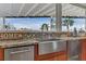 Kitchen features stainless steel sink, faucet, granite countertops, and tile backsplash with a view to the outside at 1223 Casa Palermo Circle Cir, Henderson, NV 89011