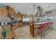 Gourmet kitchen boasts custom cabinets, stainless steel appliances, granite countertops, and breakfast bar seating at 1223 Casa Palermo Circle Cir, Henderson, NV 89011