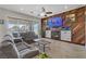 Comfortable living room featuring a fireplace, wood accent wall, and sliding doors to the backyard at 1223 Casa Palermo Circle Cir, Henderson, NV 89011
