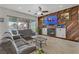 Comfortable living room featuring a fireplace, wood accent wall, and sliding doors to the backyard at 1223 Casa Palermo Circle Cir, Henderson, NV 89011