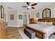 Beautiful main bedroom with a decorative window, fan, wood floors and plenty of natural light at 1223 Casa Palermo Circle Cir, Henderson, NV 89011