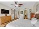 Stylish main bedroom with a ceiling fan, wood floors and open doorway to the bathroom at 1223 Casa Palermo Circle Cir, Henderson, NV 89011