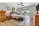 Spacious main bedroom with hardwood floors, fan, and access to the outdoor patio and backyard at 1223 Casa Palermo Circle Cir, Henderson, NV 89011