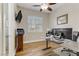 Well-lit office space with wood floors, modern desk setup, and a TV mounted on the wall at 1223 Casa Palermo Circle Cir, Henderson, NV 89011