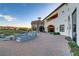 Elegant outdoor patio with fire pit, comfortable seating, and scenic golf course views, ideal for relaxation and entertainment at 1223 Casa Palermo Circle Cir, Henderson, NV 89011