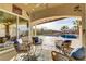 Inviting outdoor patio with comfortable seating overlooking a private pool and lush landscaping at 1223 Casa Palermo Circle Cir, Henderson, NV 89011