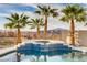 Detailed view of the pool with a tranquil waterfall feature, lush greenery, and a mountain backdrop at 1223 Casa Palermo Circle Cir, Henderson, NV 89011