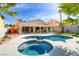 Inviting backyard oasis with a sparkling pool, spa, covered patio, and lush landscaping at 1223 Casa Palermo Circle Cir, Henderson, NV 89011
