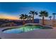Beautiful pool and spa area with lush palm trees and stunning mountain views at dusk at 1223 Casa Palermo Circle Cir, Henderson, NV 89011
