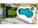 Aerial view of a freeform swimming pool, spa, and lush artificial turf at 1223 Casa Palermo Circle Cir, Henderson, NV 89011